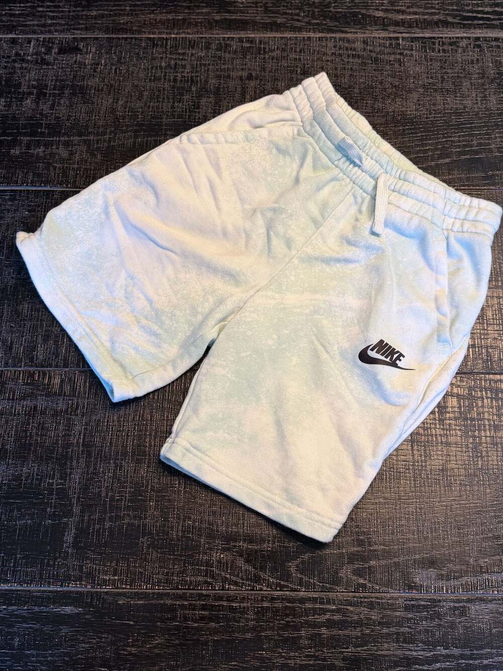 Blue and white Youth Nike shorts with color changing logo